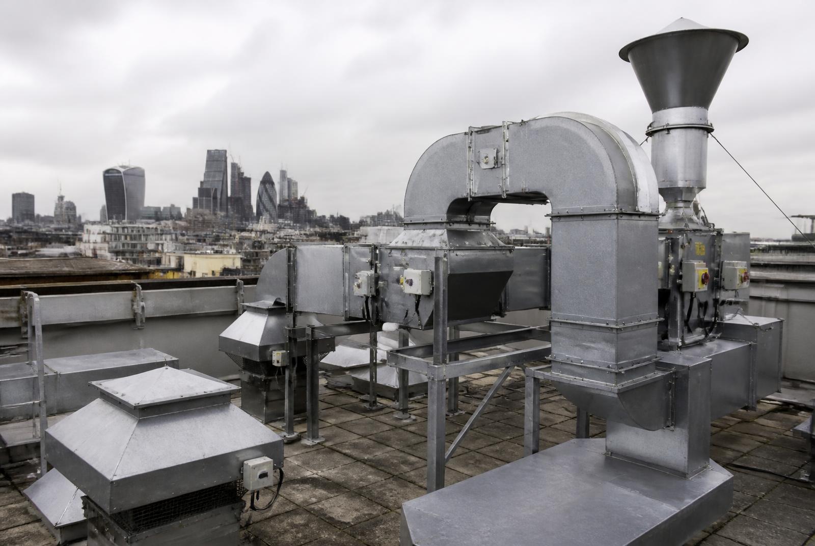 Rooftop extract ductwork and fan plant on a commercial building of the type served in Chiswick